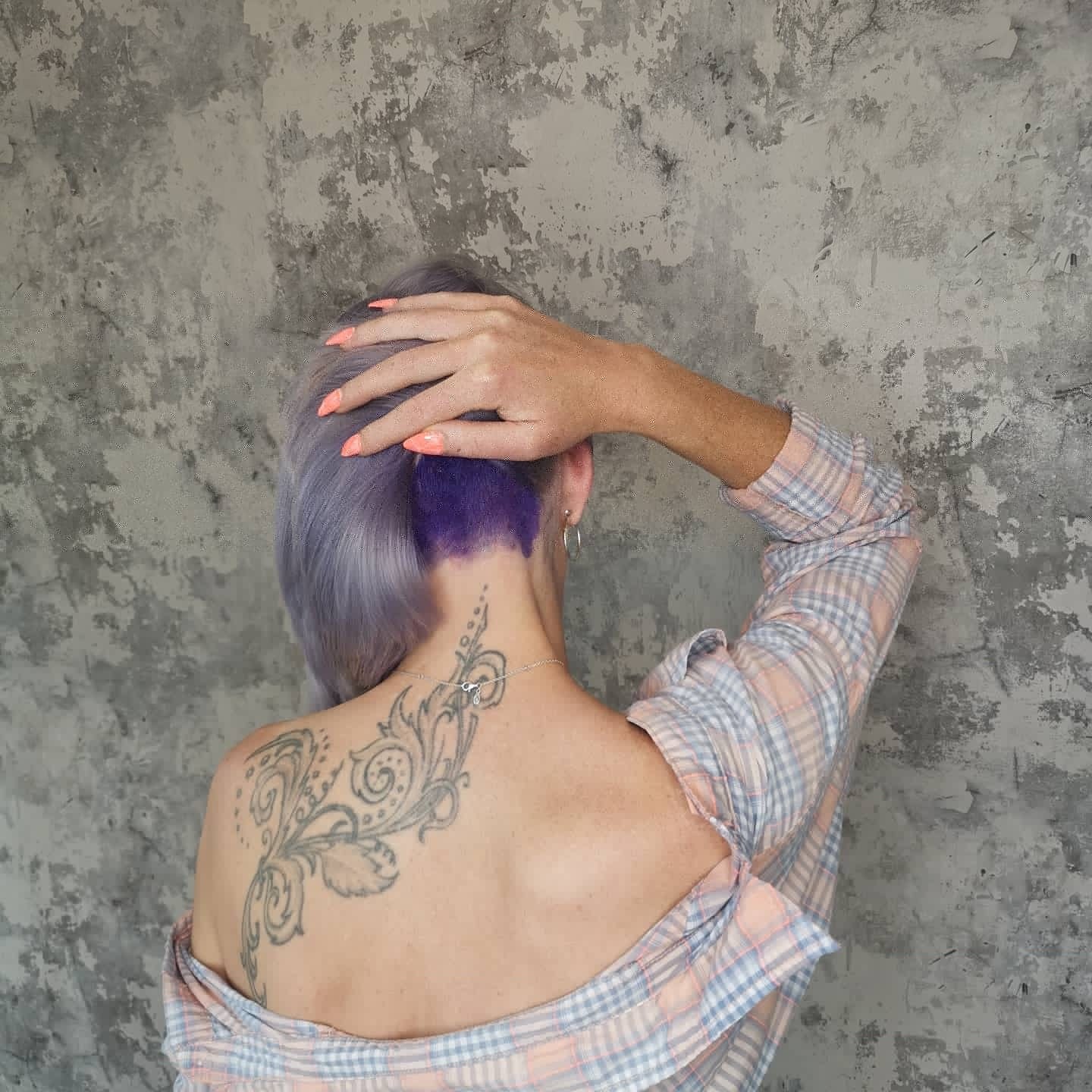 Purple undercut colour beneath a lilac bob